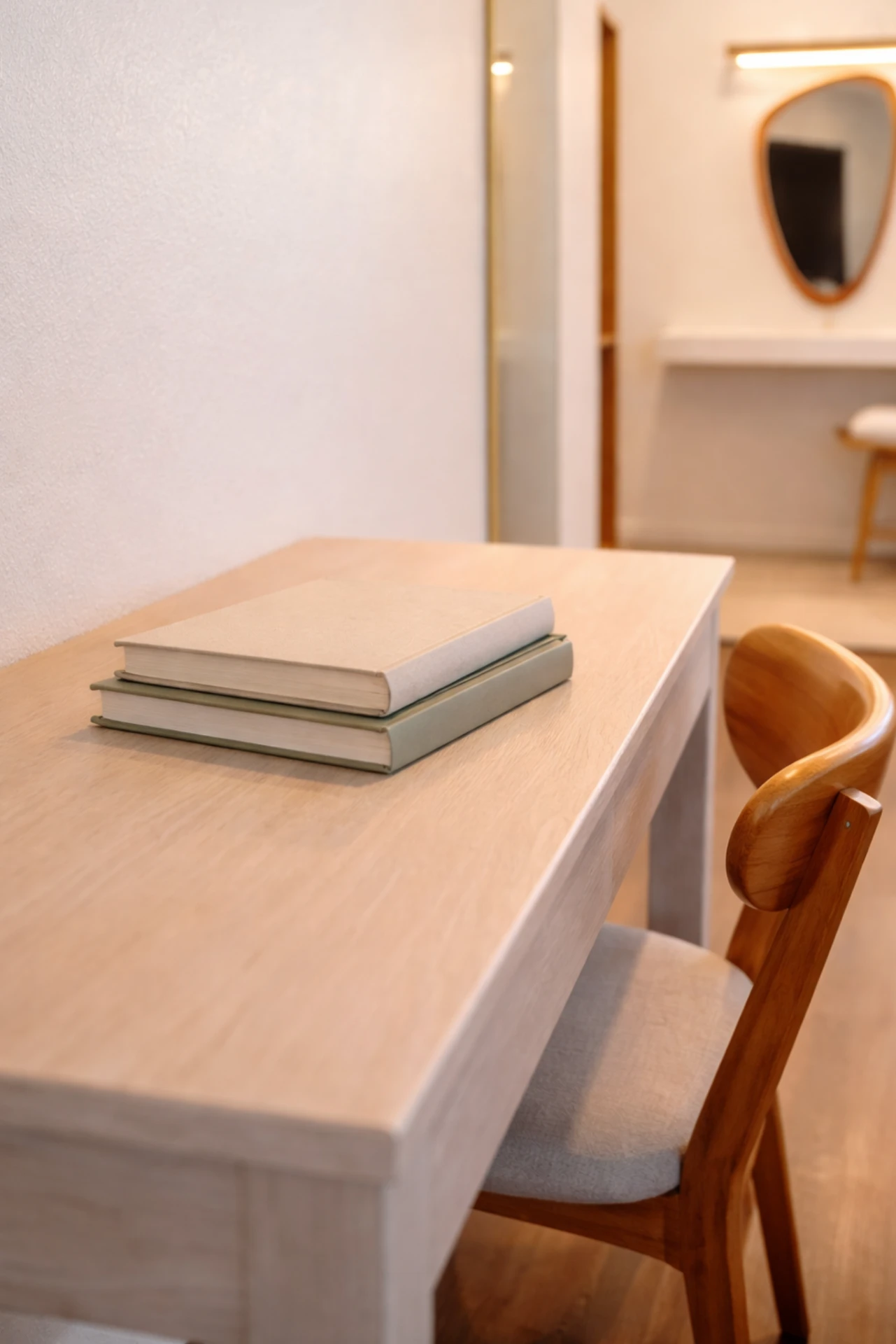 Wooden desk with books and chair in the double queen room