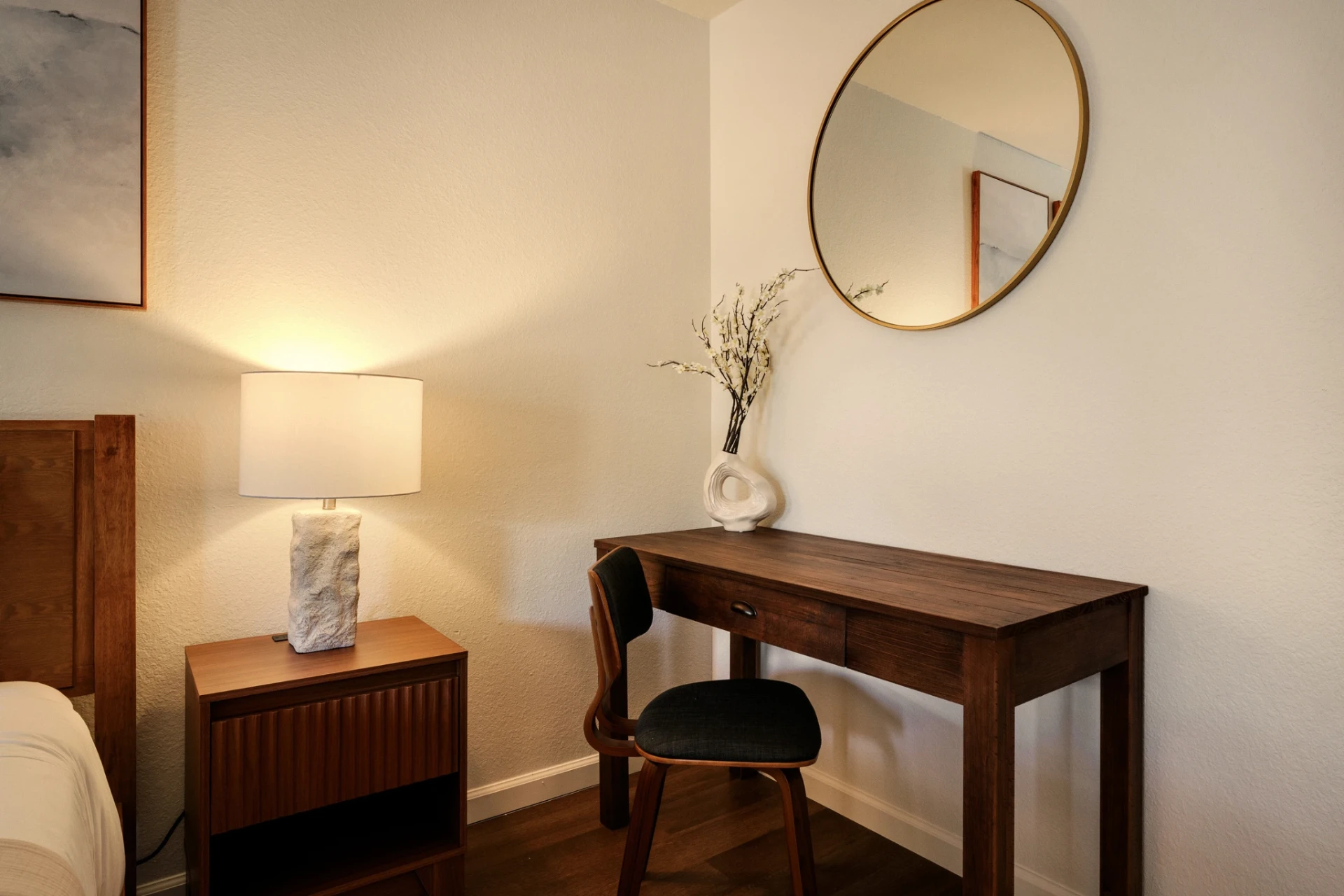 Wooden desk with round brass mirror and stone lamp