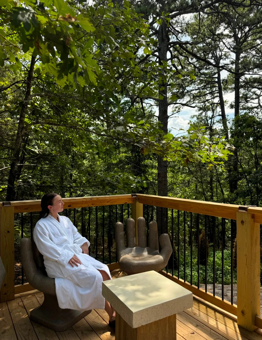 Guest relaxing in a robe on the forest deck at The Springs Spa
