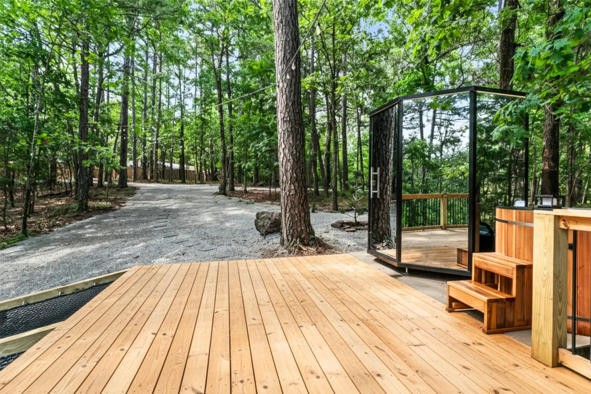 Glass Nordic sauna and cedar cold plunge on a wooden deck in the forest