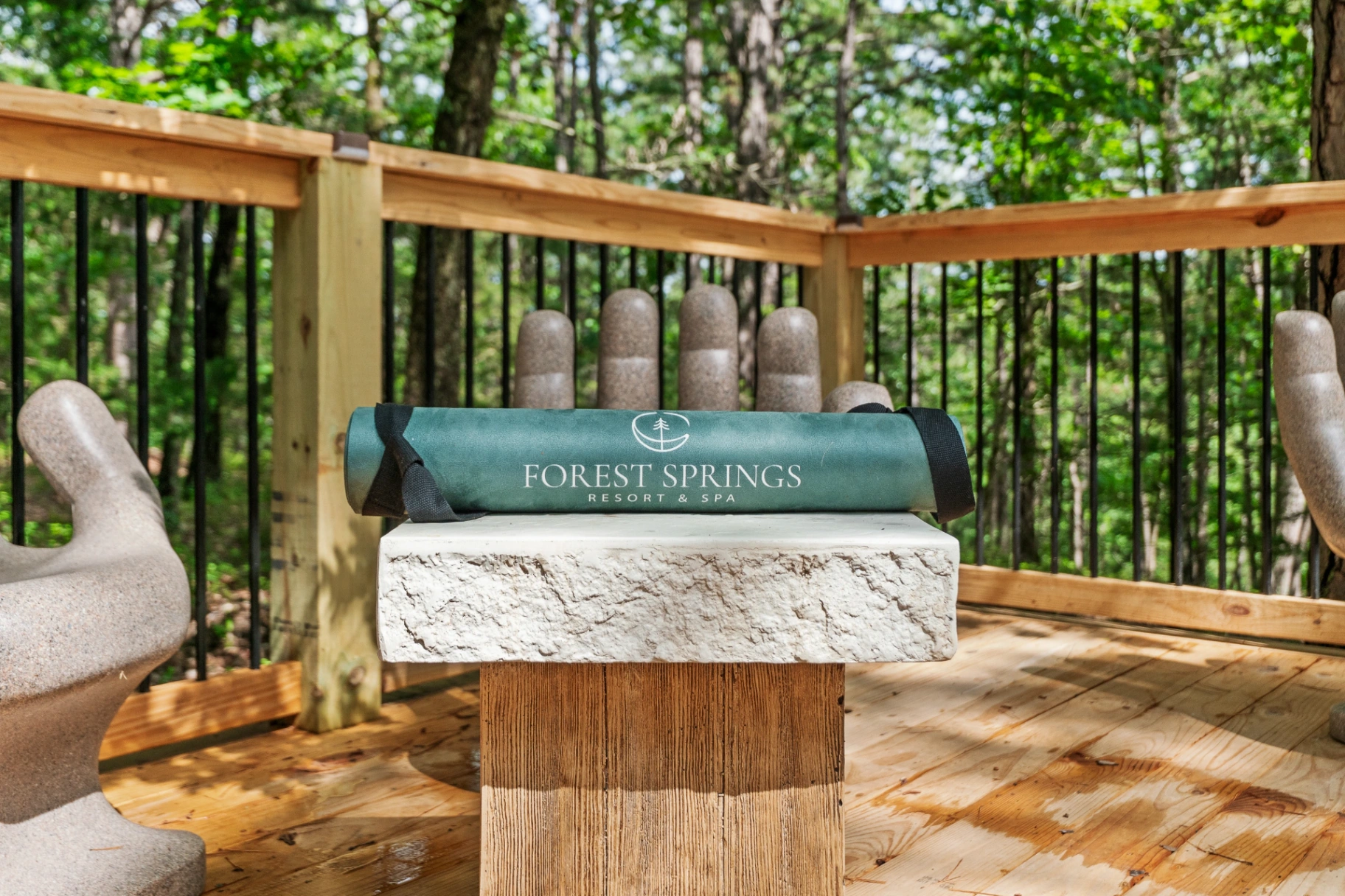 Forest Springs yoga mat resting on a stone bench on the forest deck at Forest Springs Resort, Eureka Springs Arkansas