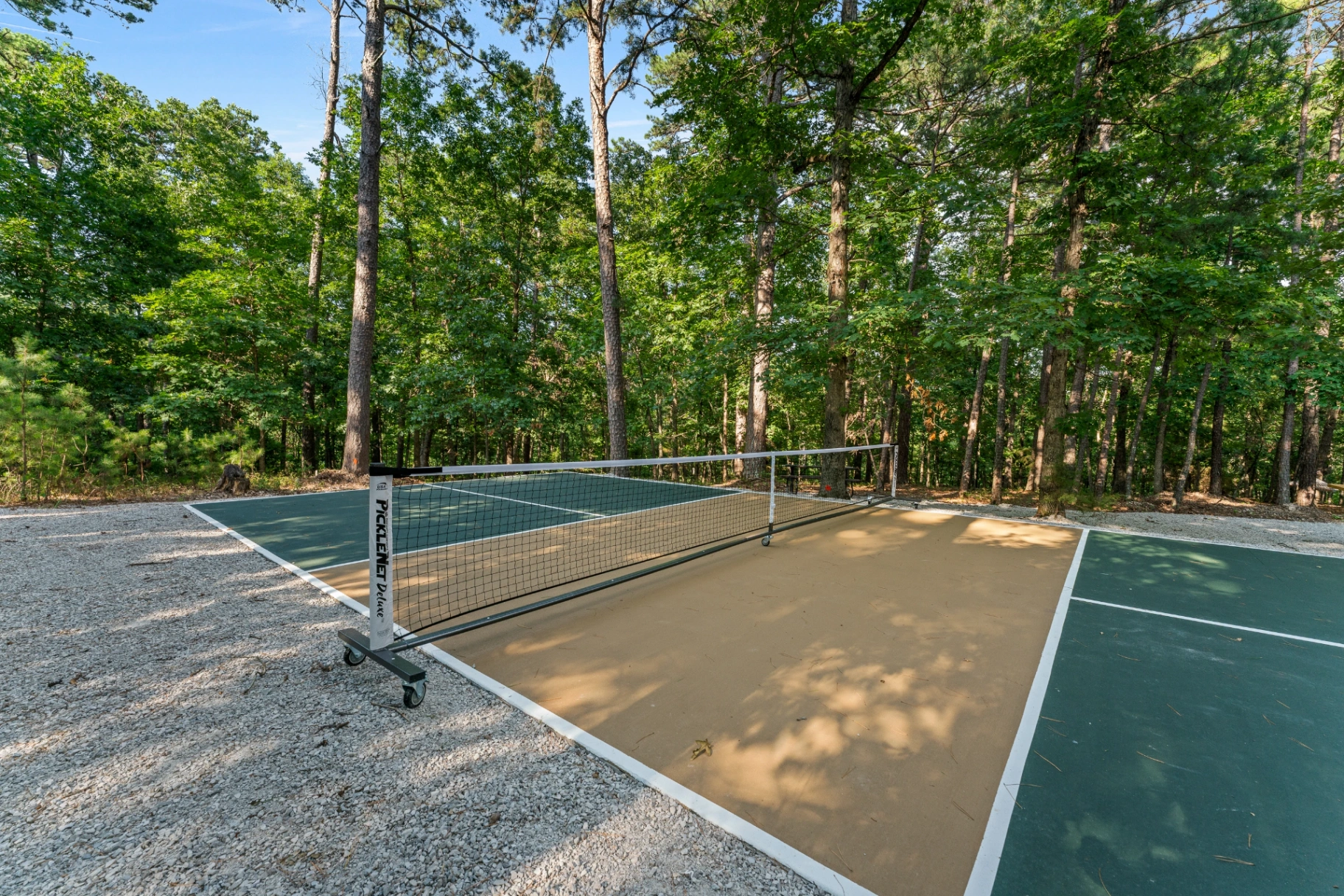 Pickleball courts surrounded by forest at Forest Springs Resort in the Ozarks