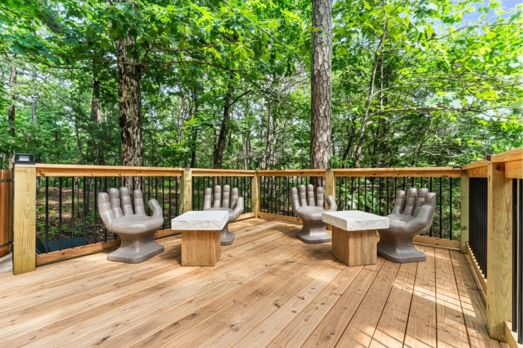 Sculptural hand chairs on the forest lounge deck at Forest Springs Resort, Eureka Springs Arkansas