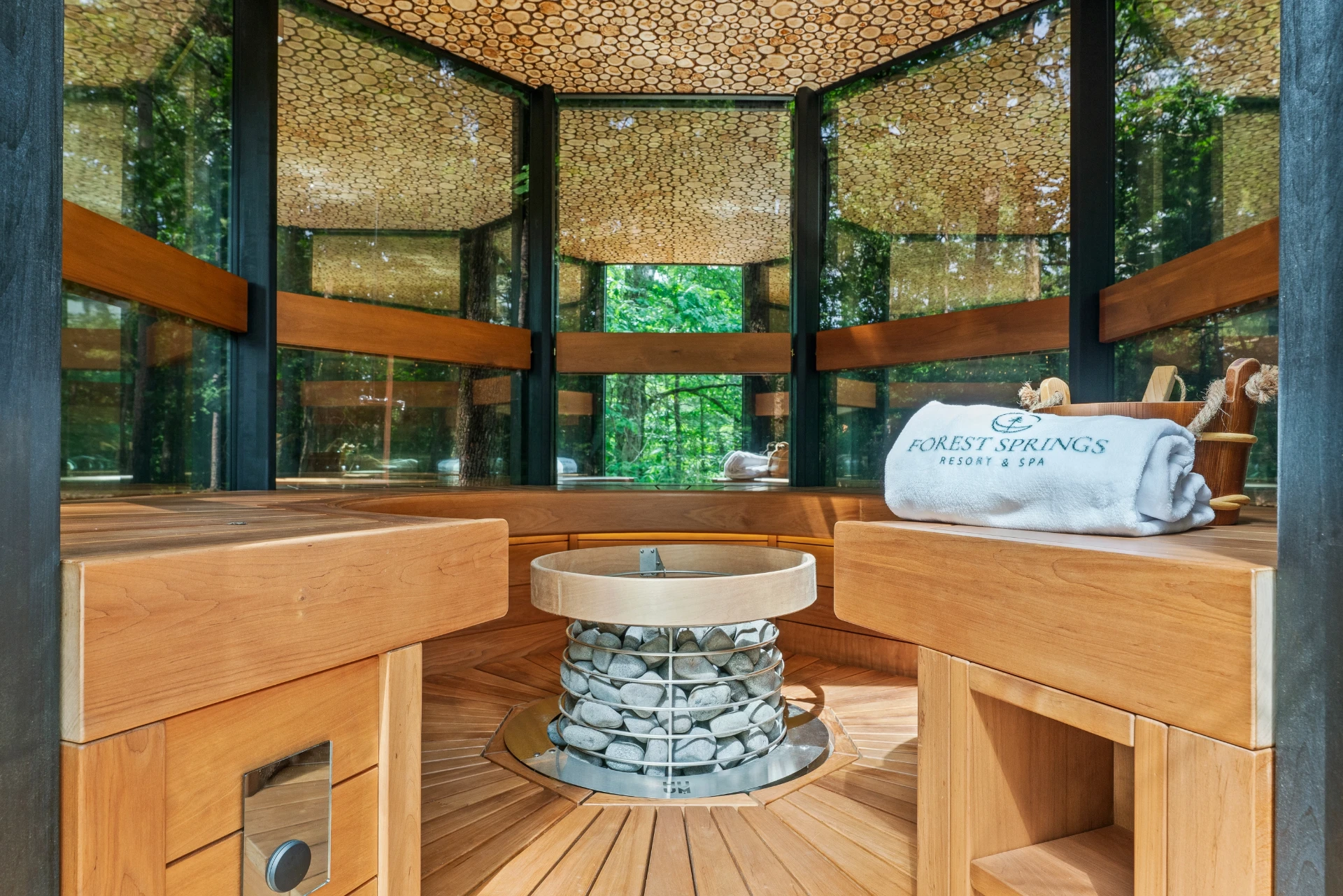 Glass-walled cedar sauna with forest views at Forest Springs Resort in the Arkansas Ozarks