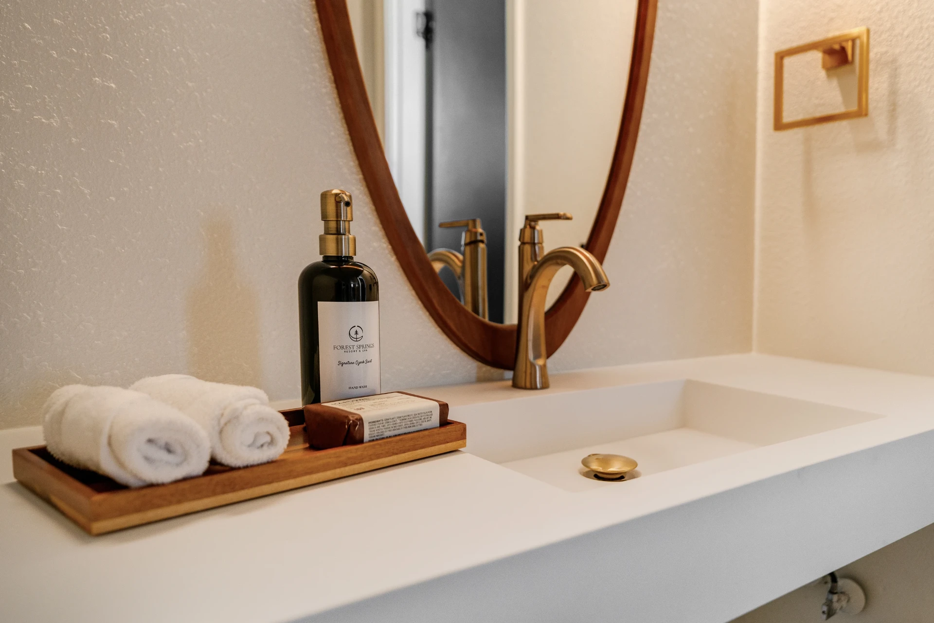 Vanity with rolled towels and Forest Springs signature hand wash