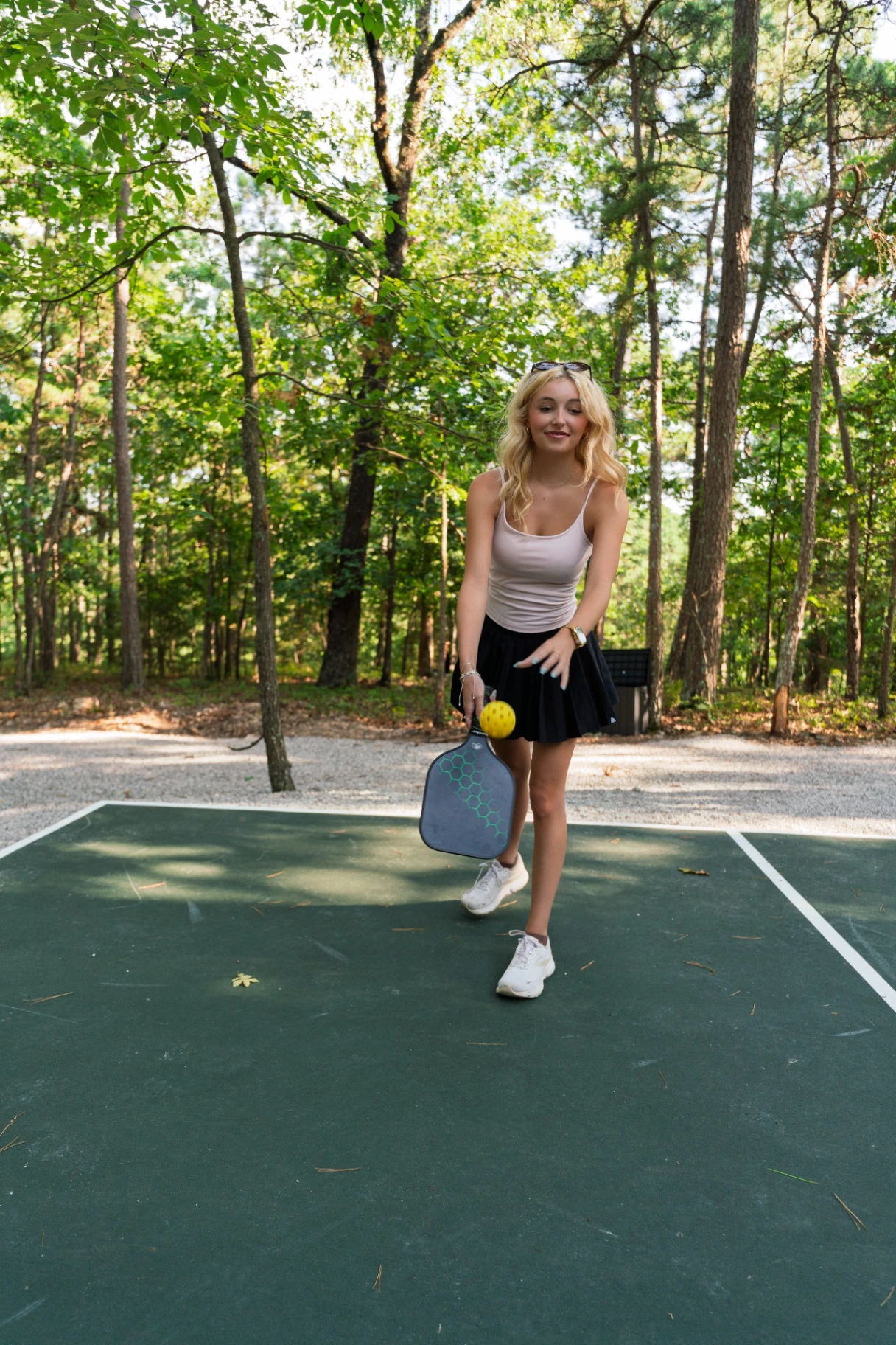 Guest playing pickleball on the wooded court at Forest Springs Resort in the Arkansas Ozarks