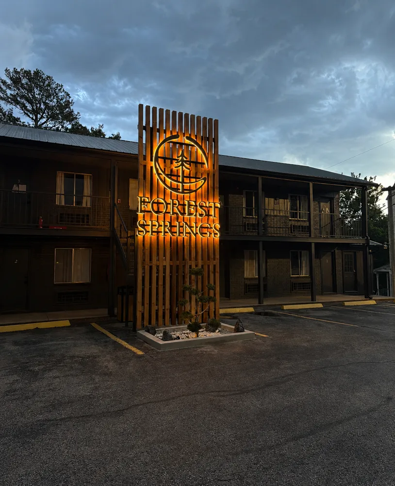 Forest Springs entrance sign lit at dusk