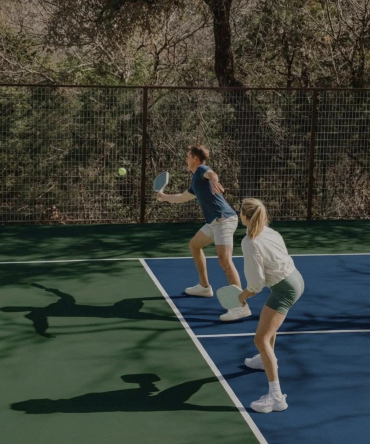 Couple playing pickleball at Forest Springs